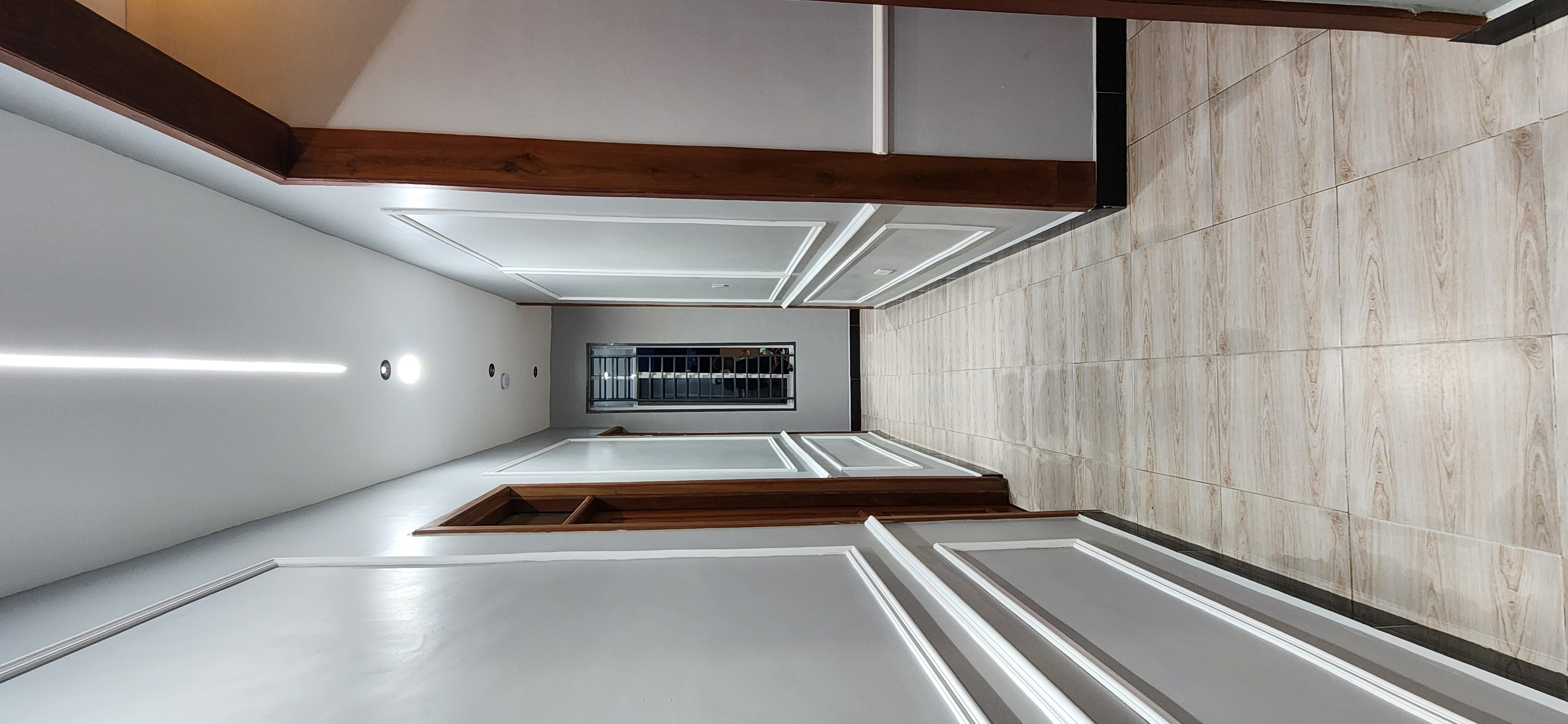 A freshly cleaned modern interior with timber accents and recessed lighting.